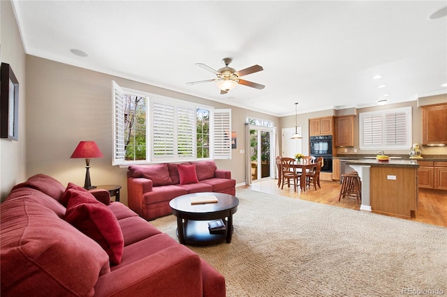 10633 Wynspire Way, Highlands Ranch, CO 80130 - living area with a ceiling fan, light colored carpet, ornamental molding, recessed lighting, and light wood-type flooring