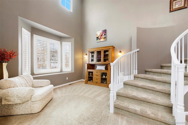 10633 Wynspire Way, Highlands Ranch, CO 80130 - foyer entrance with healthy amount of natural light, carpet flooring, a towering ceiling, and stairs
