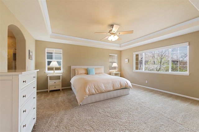 10633 Wynspire Way, Highlands Ranch, CO 80130 - bedroom featuring a raised ceiling, light colored carpet, arched walkways, and ceiling fan