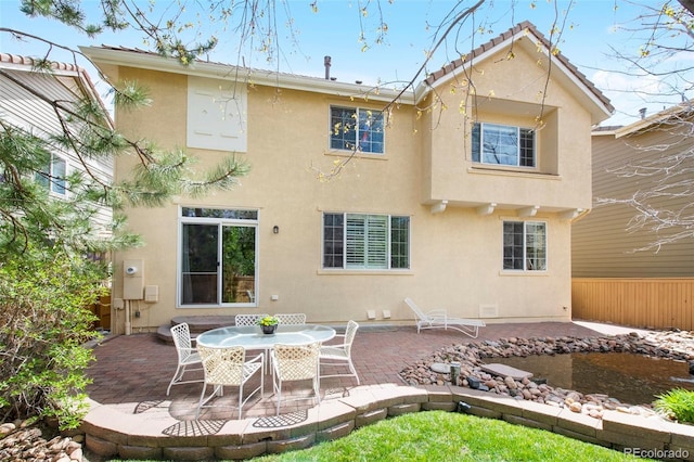 10633 Wynspire Way, Highlands Ranch, CO 80130 - back of house with stucco siding and a patio area