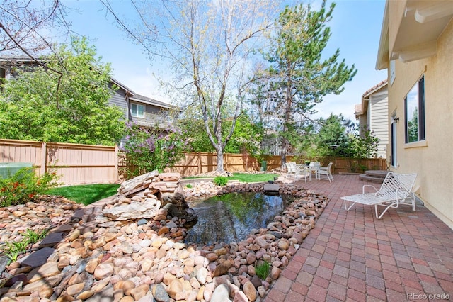 10633 Wynspire Way, Highlands Ranch, CO 80130 - fenced backyard with a patio and a garden pond