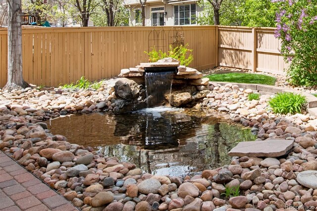 10633 Wynspire Way, Highlands Ranch, CO 80130 - view of yard featuring a garden pond