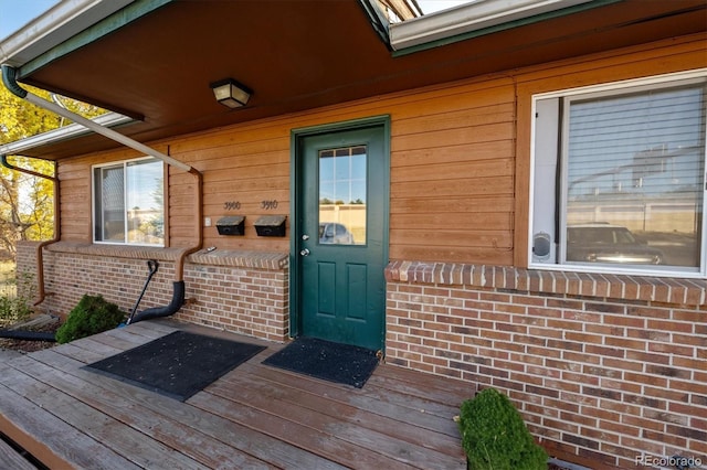 view of exterior entry featuring a deck