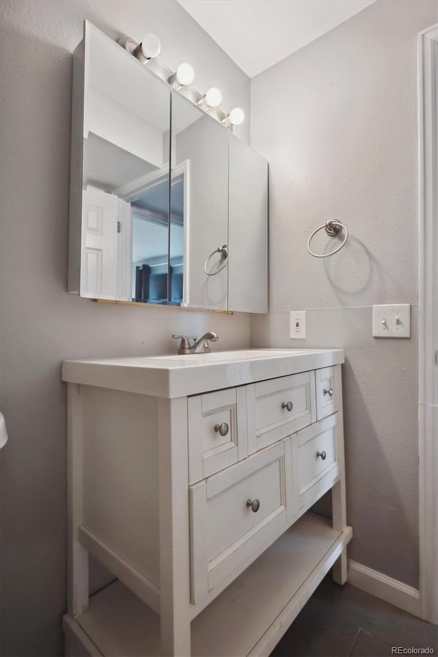 3900 Turnpike Dr, Westminster, CO 80030 - bathroom with baseboards and vanity
