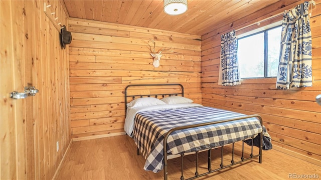 bedroom with wood ceiling, wood walls, and wood-type flooring