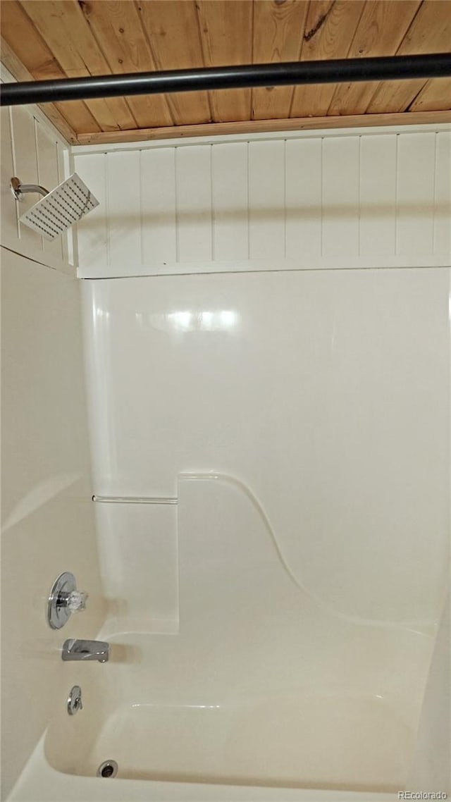 bathroom featuring  shower combination and wood ceiling