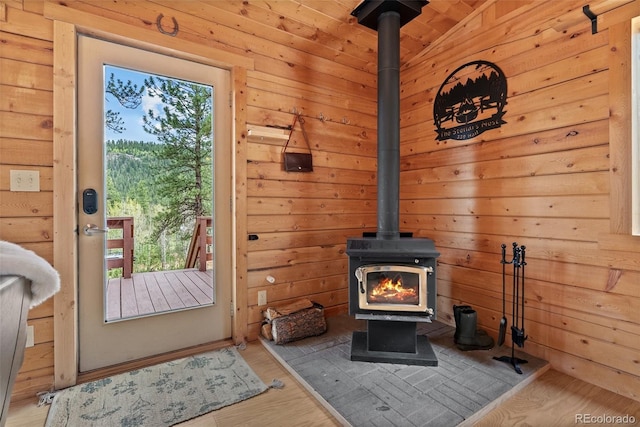 339 Hall Rd, Bailey, CO 80421 - doorway to outside with a wood stove, wooden walls, and wood finished floors