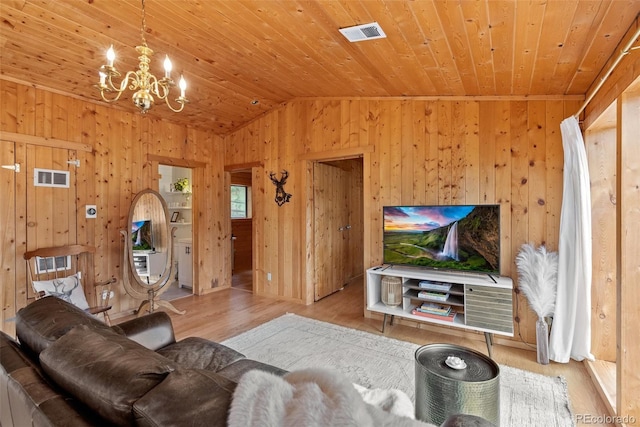 339 Hall Rd, Bailey, CO 80421 - living room featuring wood ceiling, wood finished floors, a chandelier, lofted ceiling, and wood walls