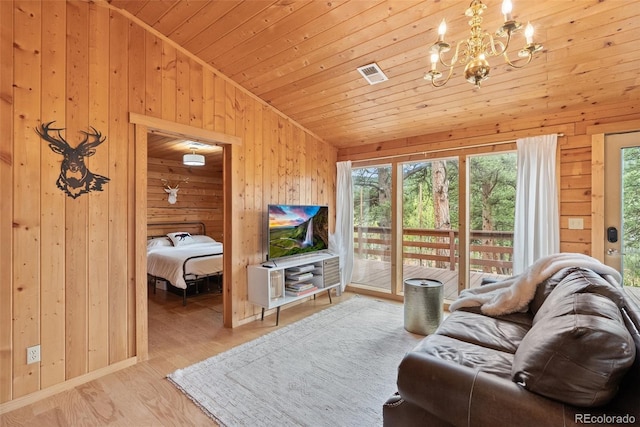 339 Hall Rd, Bailey, CO 80421 - living room with vaulted ceiling, wooden walls, a chandelier, wood finished floors, and wood ceiling