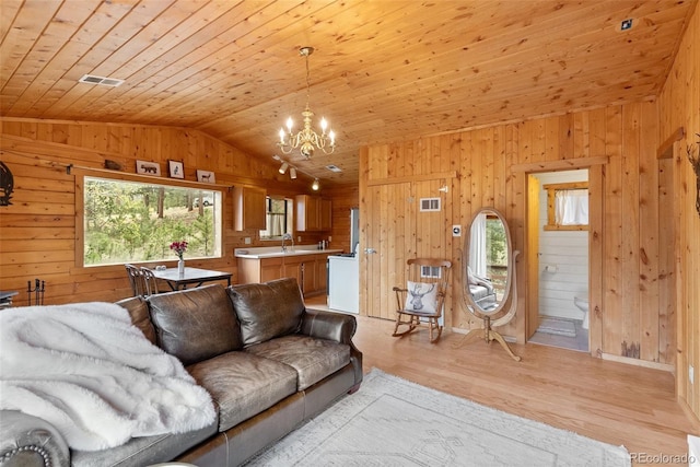 339 Hall Rd, Bailey, CO 80421 - living area with lofted ceiling, healthy amount of natural light, wood walls, a chandelier, and wood ceiling