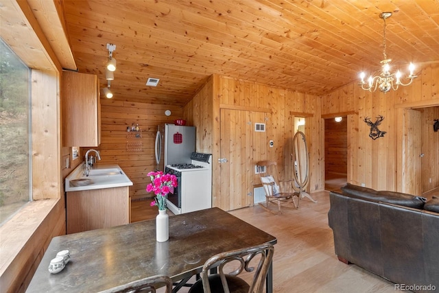 339 Hall Rd, Bailey, CO 80421 - dining room featuring wood walls, a chandelier, wooden ceiling, light wood-type flooring, and lofted ceiling