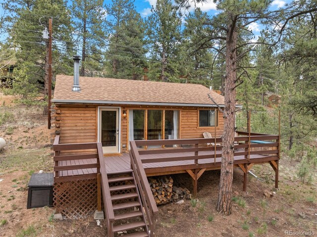 339 Hall Rd, Bailey, CO 80421 - back of house with a shingled roof, a deck, and view of wooded area