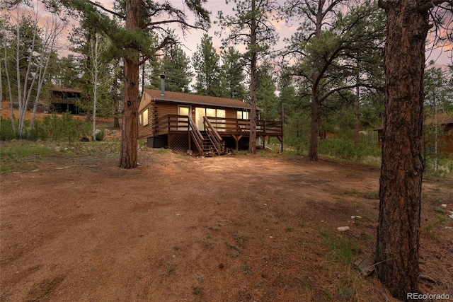339 Hall Rd, Bailey, CO 80421 - yard at dusk featuring a wooden deck and stairs