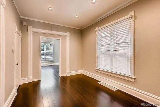 1365 Clayton St, Denver, CO 80206 - empty room featuring crown molding, wood-type flooring, and baseboards