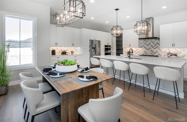 dining room with sink and hardwood / wood-style floors