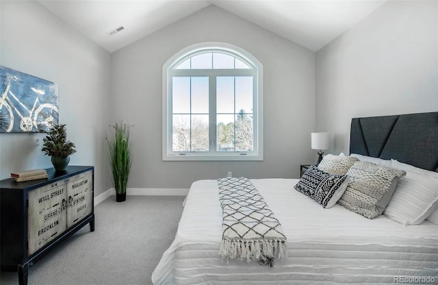 bedroom featuring lofted ceiling and carpet