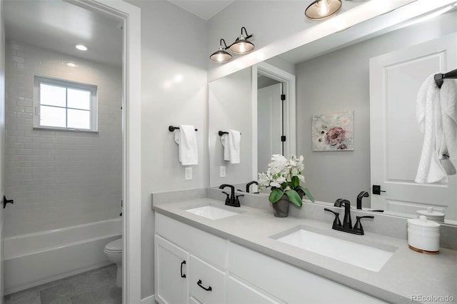 full bathroom featuring tile patterned floors, vanity, toilet, and tiled shower / bath combo