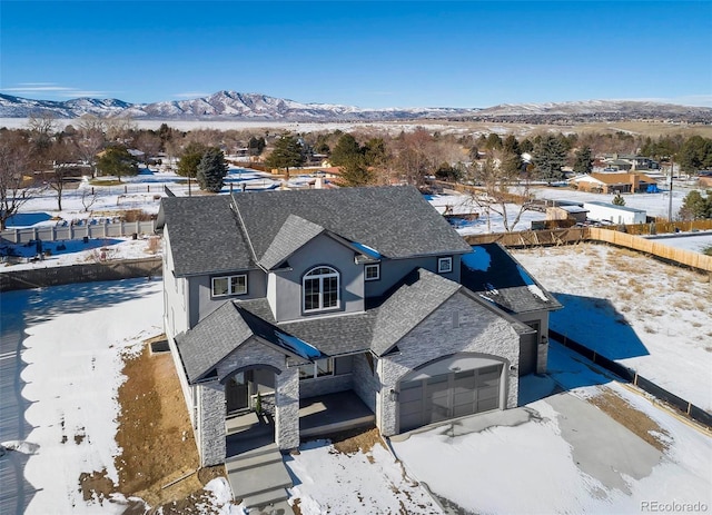 snowy aerial view with a mountain view