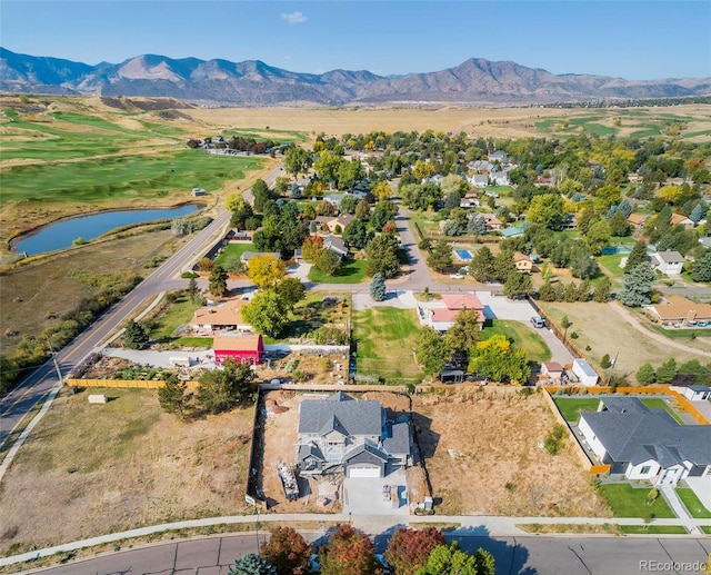 drone / aerial view with a water and mountain view