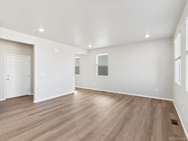 empty room featuring recessed lighting, visible vents, baseboards, and light wood finished floors