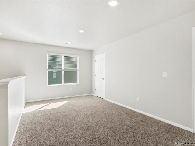 spare room with recessed lighting, baseboards, and carpet floors