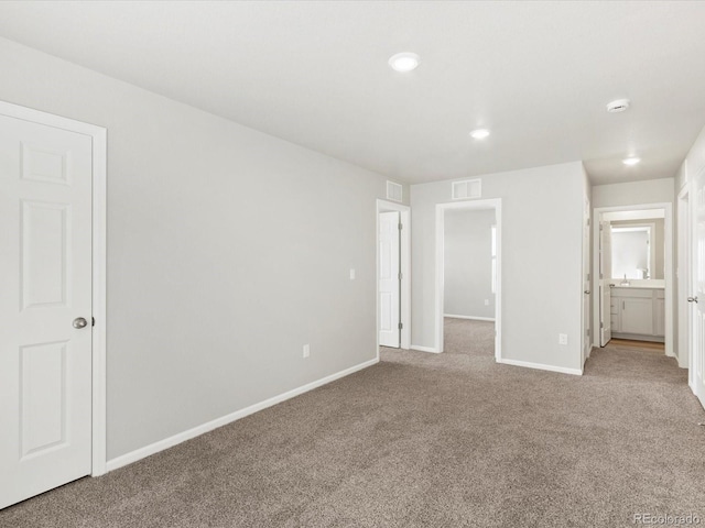 unfurnished bedroom featuring recessed lighting, visible vents, carpet floors, and baseboards