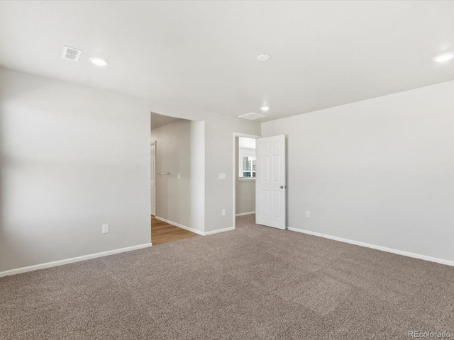 carpeted spare room featuring recessed lighting and baseboards