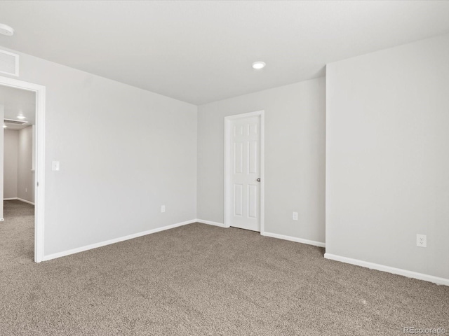 carpeted empty room with recessed lighting, visible vents, and baseboards