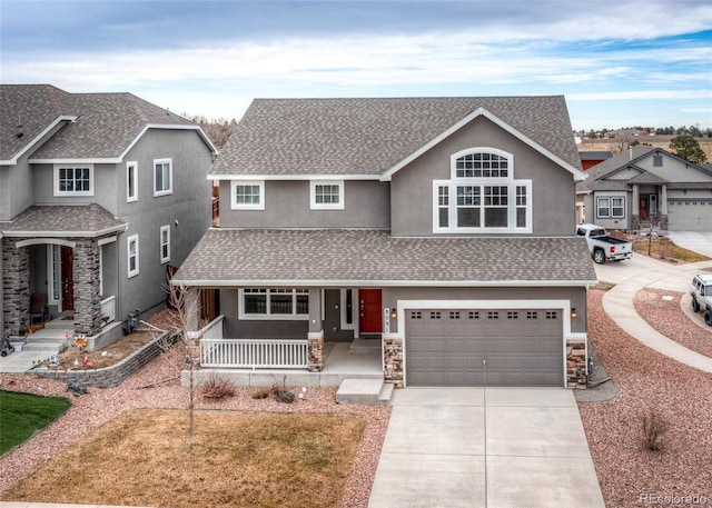 view of front of home with a porch and a garage