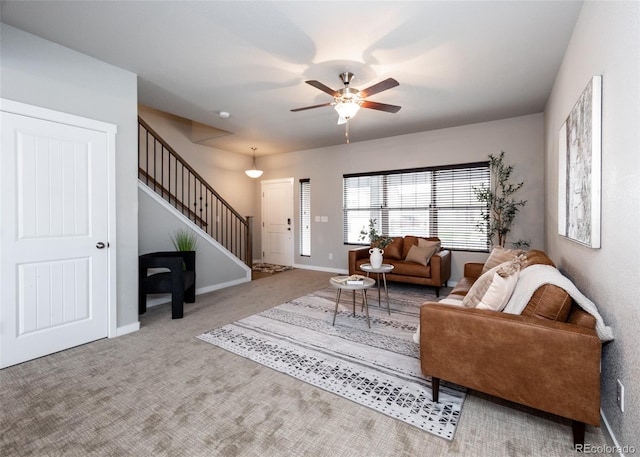 carpeted living room with ceiling fan