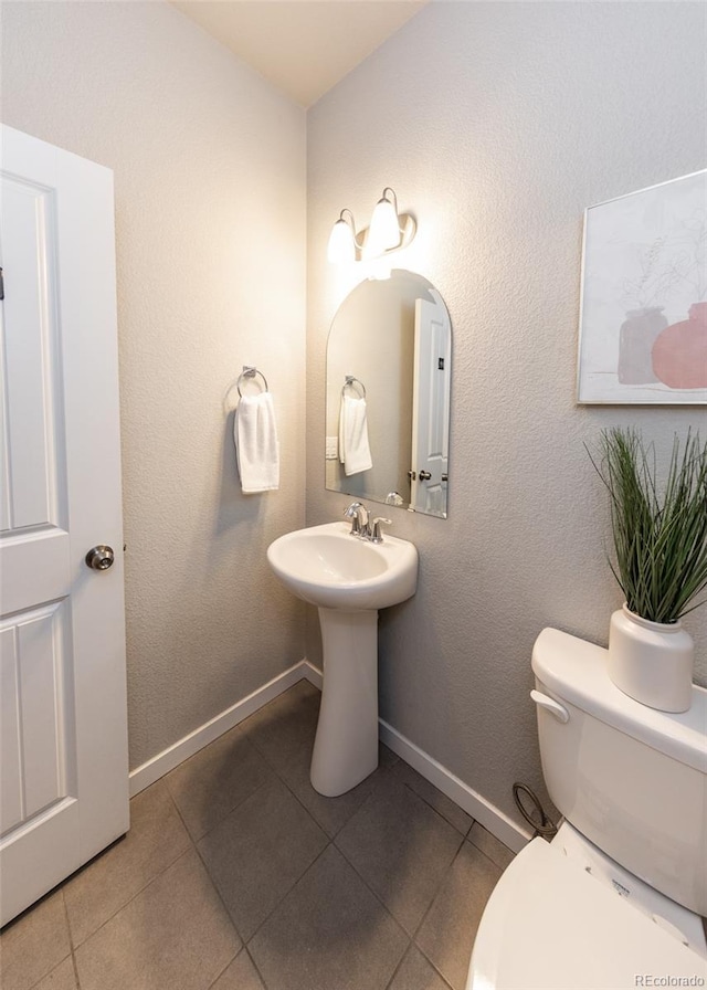 bathroom featuring tile patterned floors, sink, and toilet