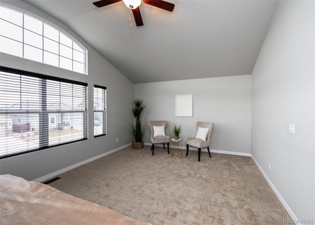 living area featuring light carpet, ceiling fan, and lofted ceiling