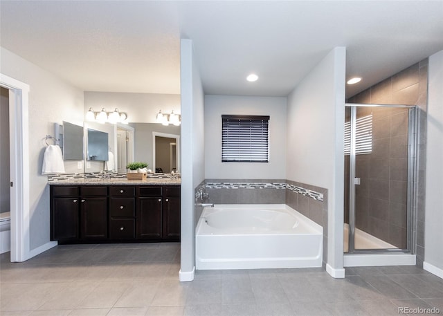 full bathroom with tile patterned flooring, vanity, independent shower and bath, and toilet