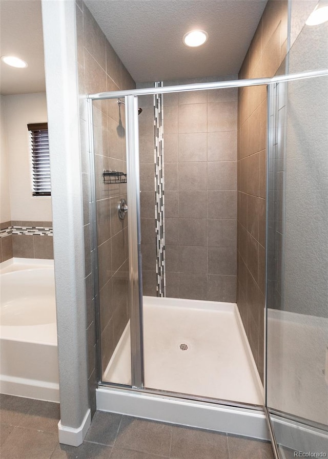 bathroom featuring tile patterned floors and a shower with door