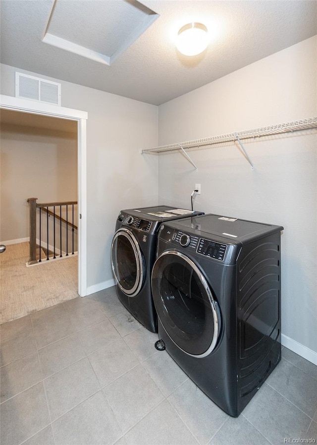 clothes washing area featuring washing machine and clothes dryer