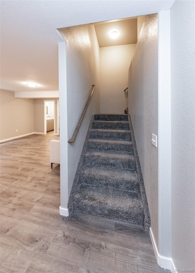 stairs with hardwood / wood-style flooring