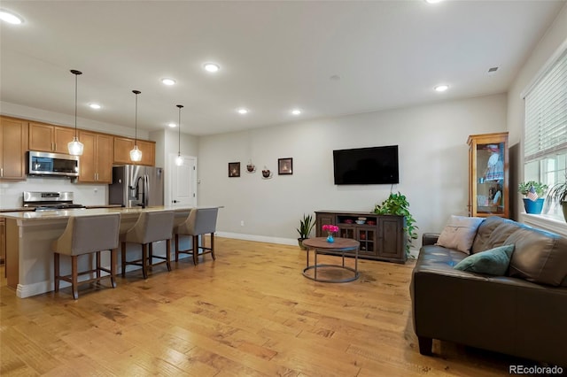 16461 E 119th Way Unit B, Commerce City, CO 80022 - living area featuring light wood-style flooring and recessed lighting