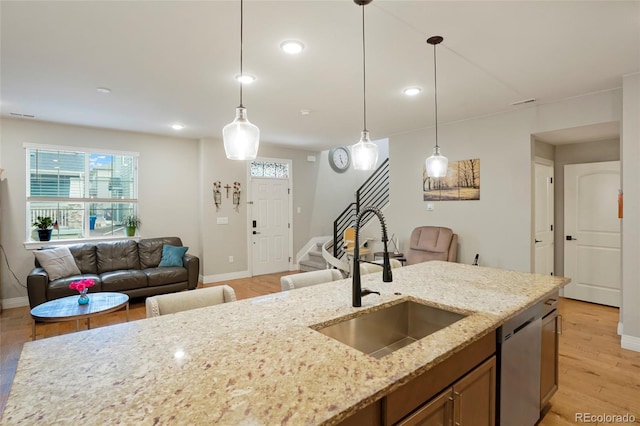 16461 E 119th Way Unit B, Commerce City, CO 80022 - kitchen with open floor plan, stainless steel dishwasher, light wood-type flooring, pendant lighting, and recessed lighting