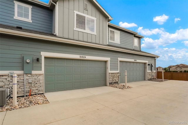 16461 E 119th Way Unit B, Commerce City, CO 80022 - view of front facade with a garage, stone siding, board and batten siding, and concrete driveway