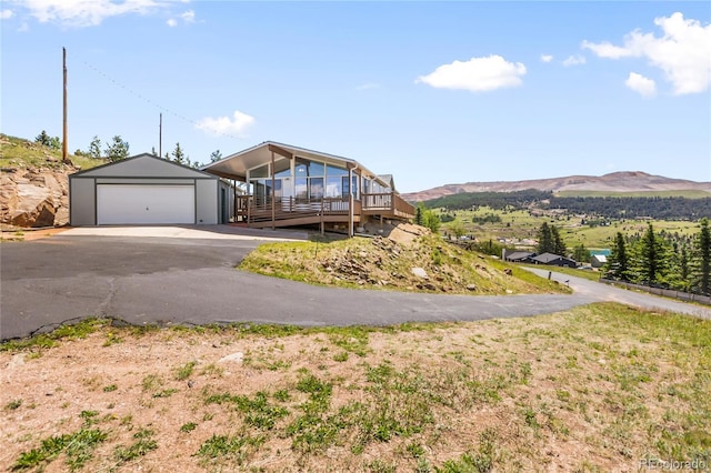 235 W May St, Cripple Creek, CO 80813 - view of front of house with a garage, an outbuilding, and a deck with mountain view