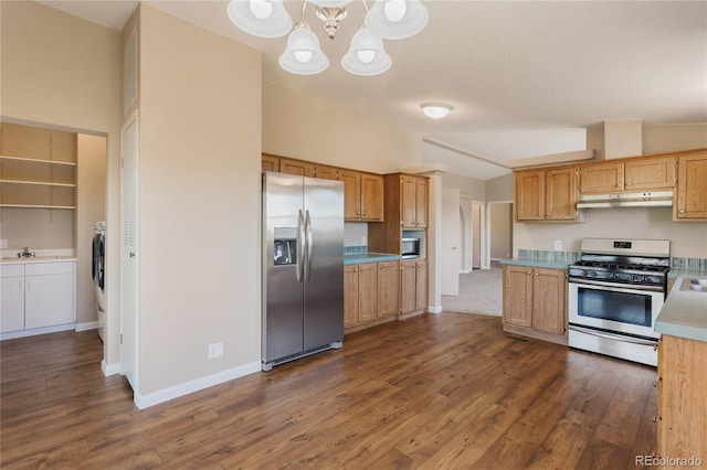 235 W May St, Cripple Creek, CO 80813 - kitchen with appliances with stainless steel finishes, under cabinet range hood, dark wood finished floors, light countertops, and a chandelier