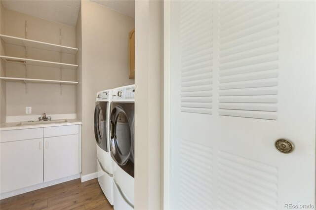 235 W May St, Cripple Creek, CO 80813 - washroom with independent washer and dryer, cabinet space, and wood finished floors