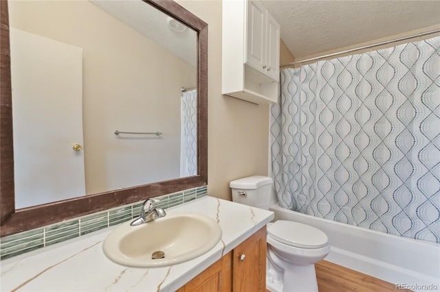 235 W May St, Cripple Creek, CO 80813 - bathroom with vanity, a textured ceiling, shower / bath combo with shower curtain, wood finished floors, and decorative backsplash