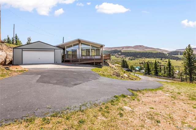 235 W May St, Cripple Creek, CO 80813 - view of front facade with a deck with mountain view, a garage, and an outdoor structure