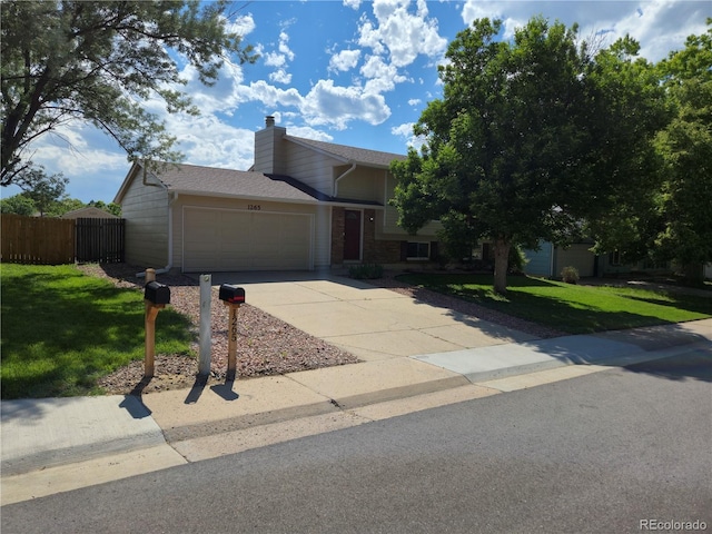 1265 S Biscay St, Aurora, CO 80017 - view of front facade with a garage, driveway, a chimney, brick siding, and a shingled roof