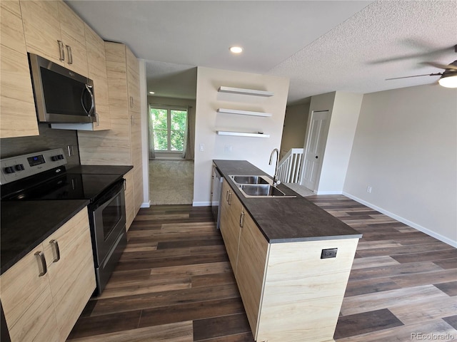 1265 S Biscay St, Aurora, CO 80017 - kitchen featuring appliances with stainless steel finishes, dark countertops, light brown cabinets, dark wood finished floors, and recessed lighting