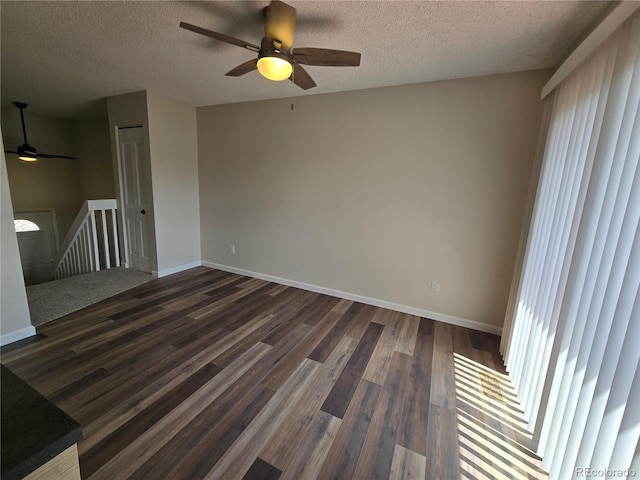 1265 S Biscay St, Aurora, CO 80017 - spare room featuring a ceiling fan, a textured ceiling, and dark wood-style floors