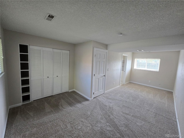 1265 S Biscay St, Aurora, CO 80017 - unfurnished bedroom featuring carpet, a closet, and a textured ceiling