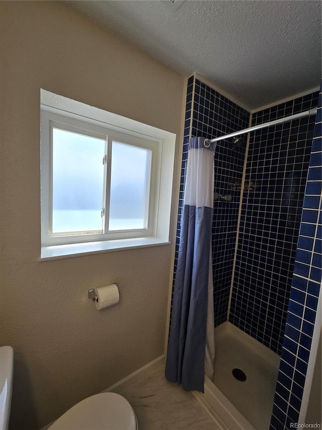 1265 S Biscay St, Aurora, CO 80017 - full bathroom featuring a stall shower and a textured ceiling