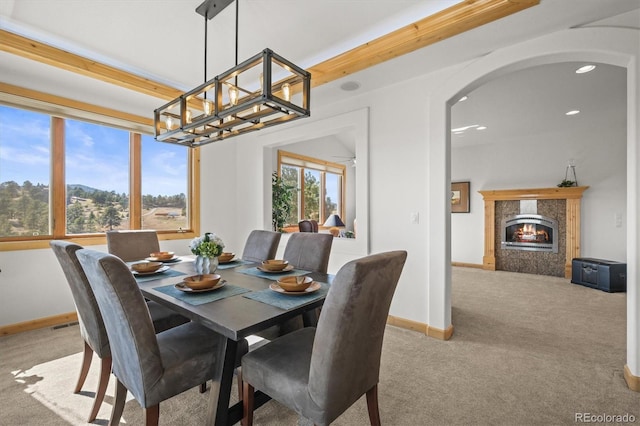 156 S Lookout Mountain Rd, Golden, CO 80401 - carpeted dining room with arched walkways, baseboards, a chandelier, a fireplace, and recessed lighting